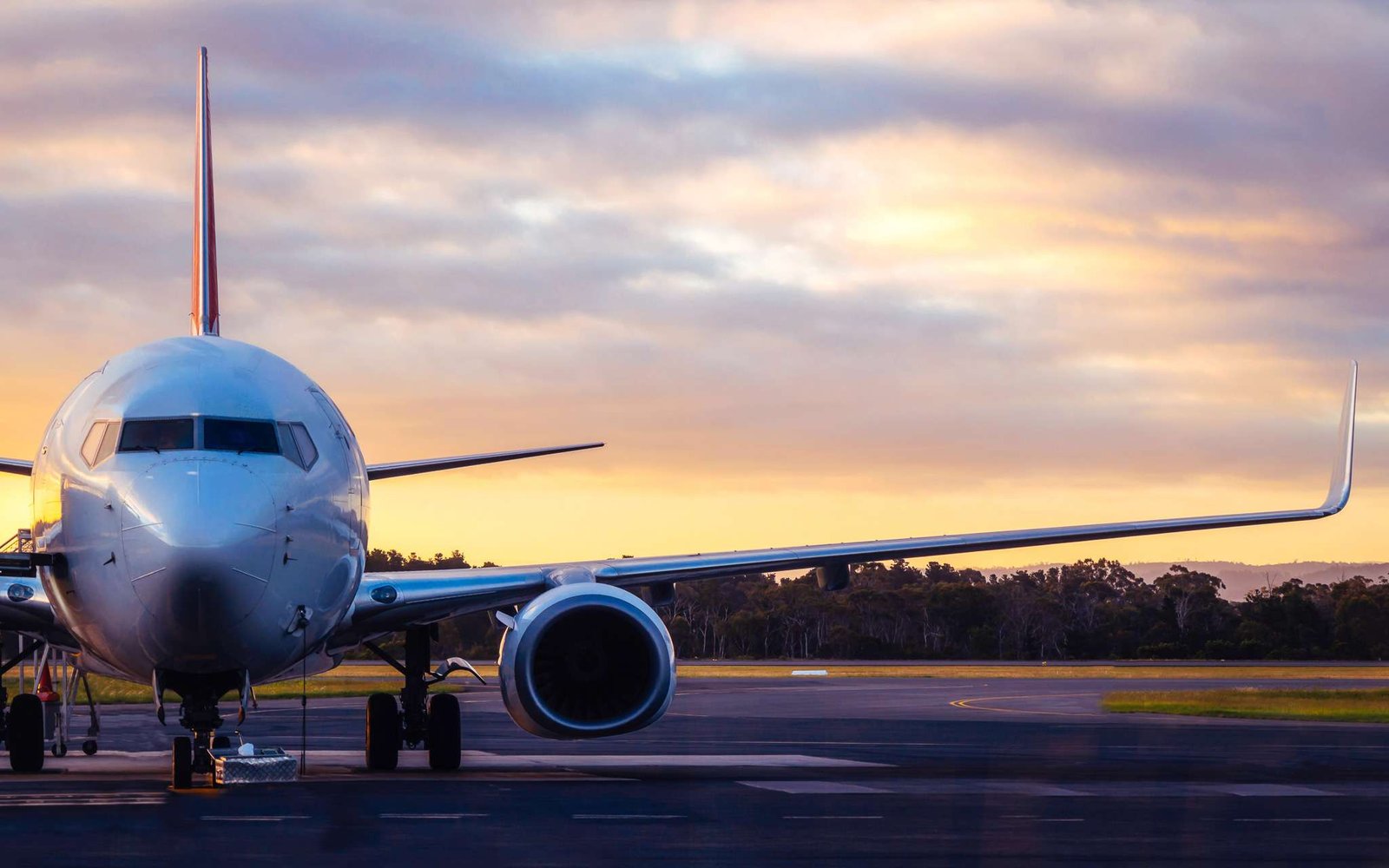 Sunset view of airplane on airport runway
