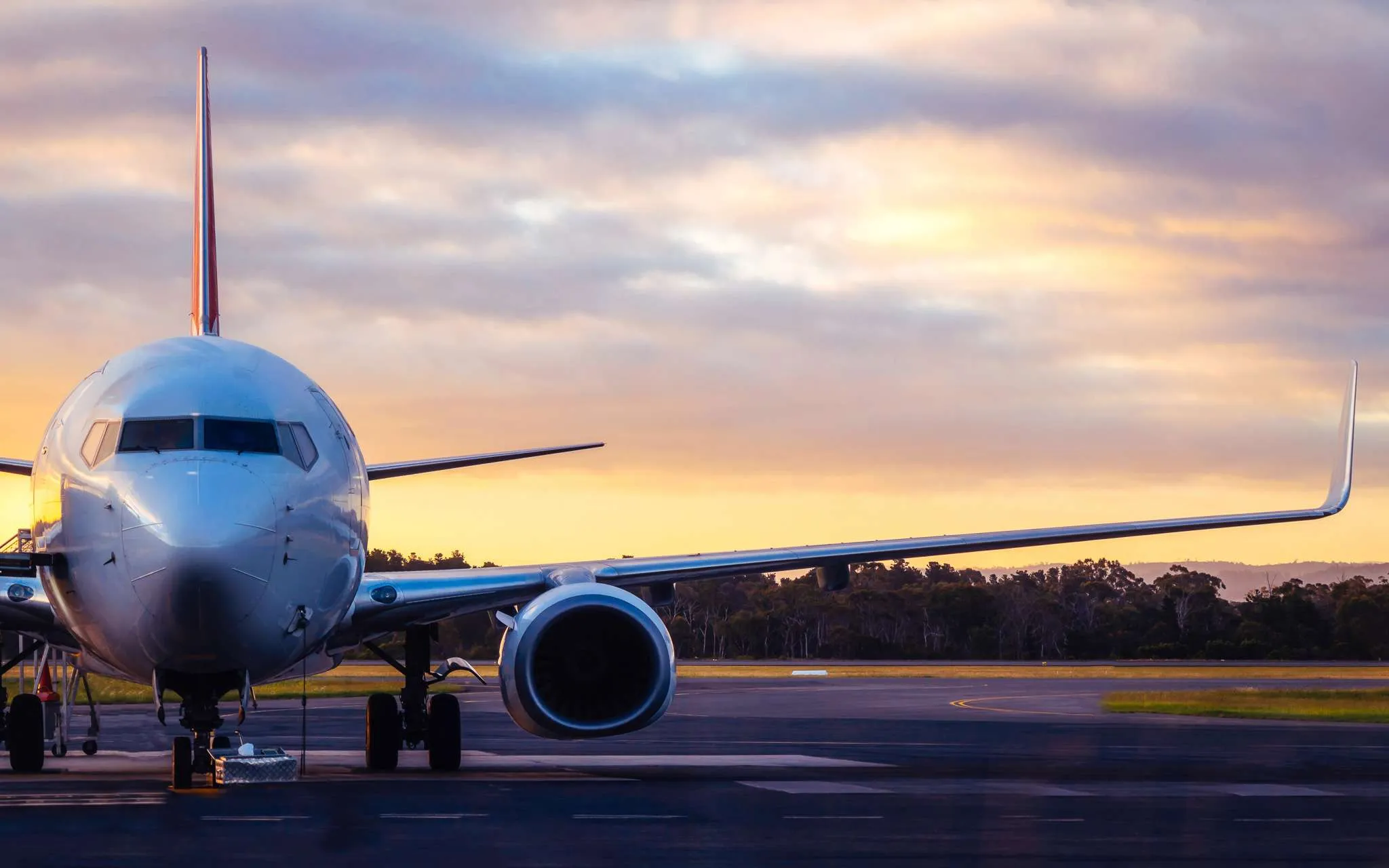 Sunset view of airplane on airport runway