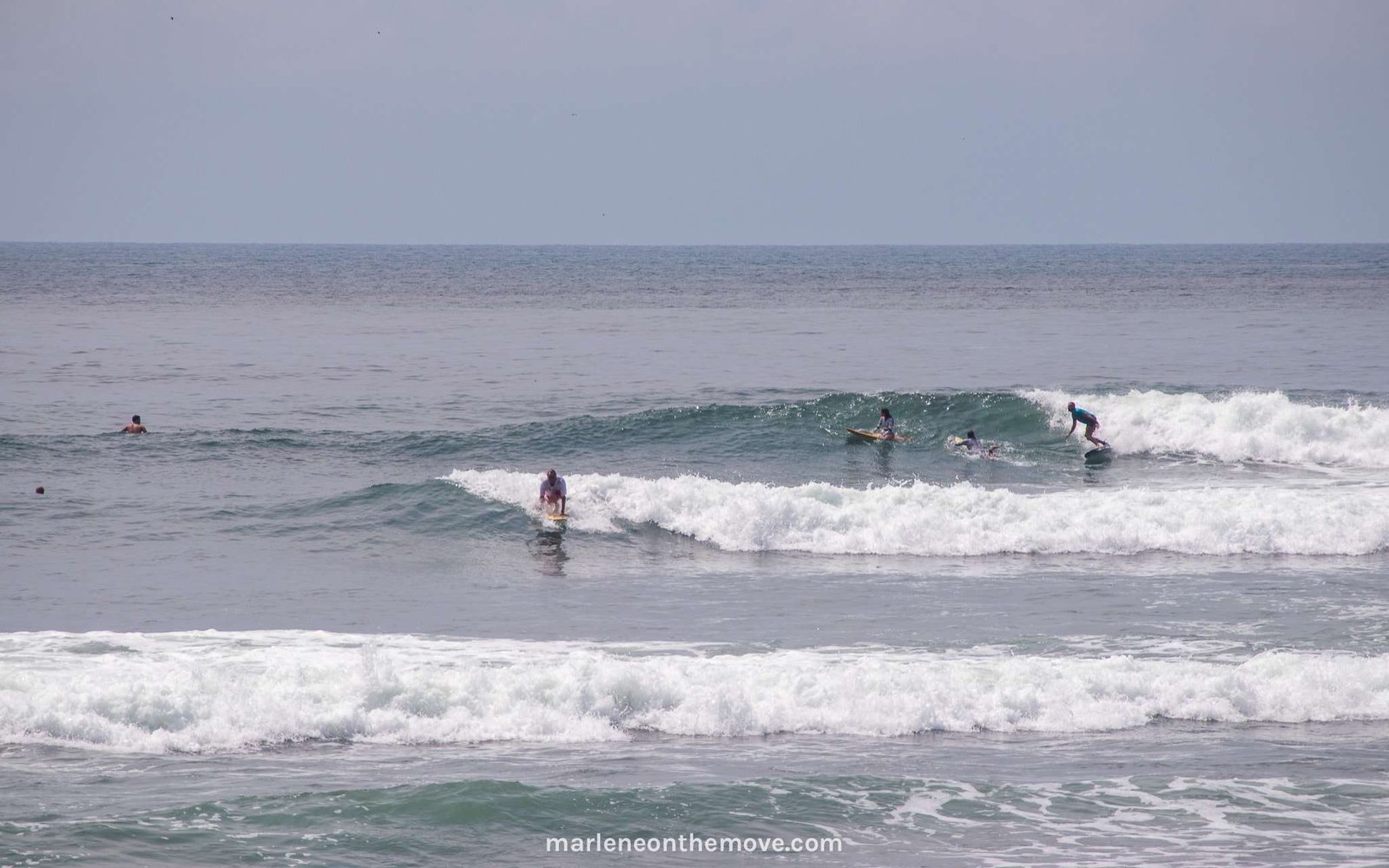 Surfers surfing in El Sunzal, El Salvador