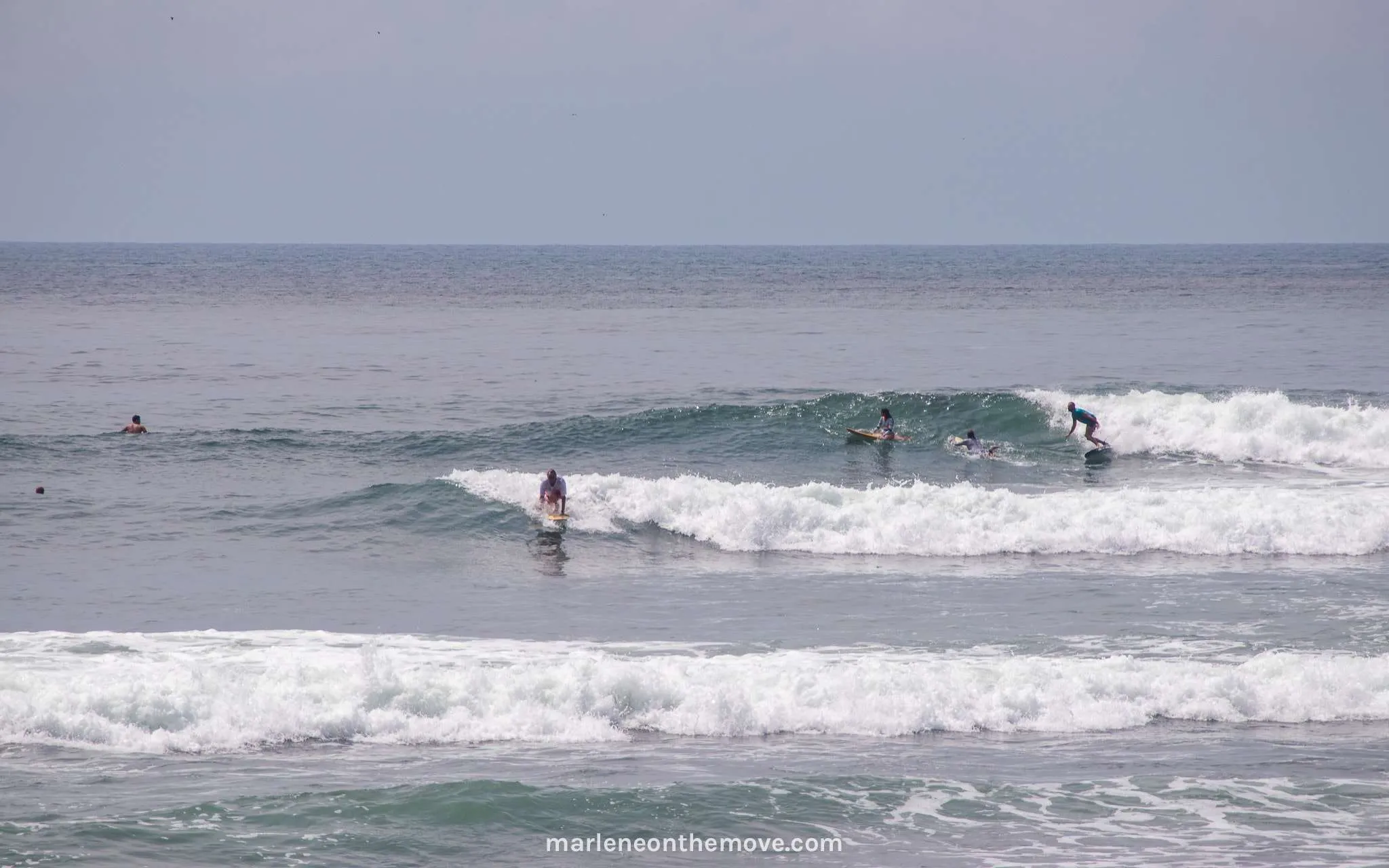 Surfers surfing in El Sunzal, El Salvador