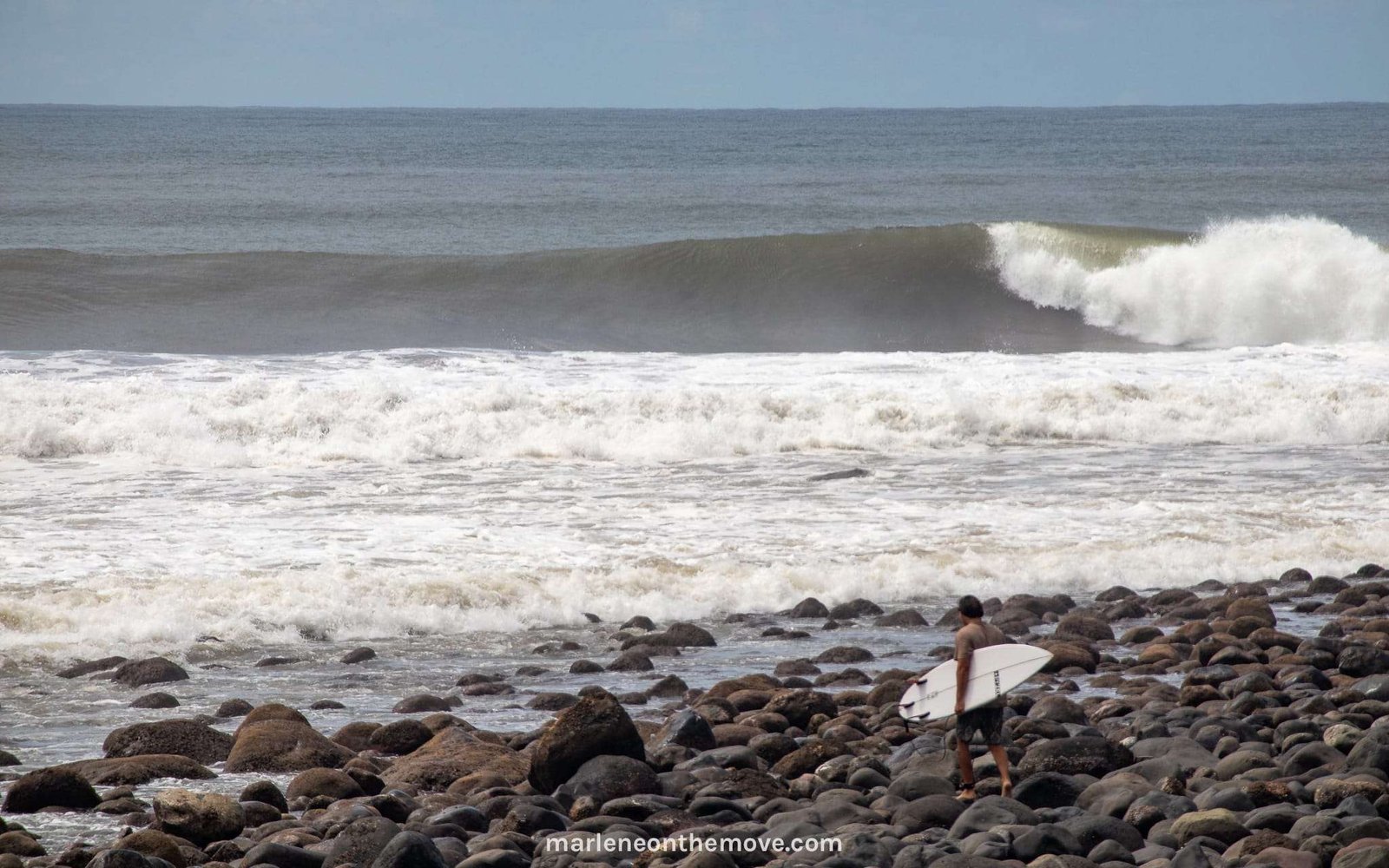 Surfer entering the water in Punta Mango