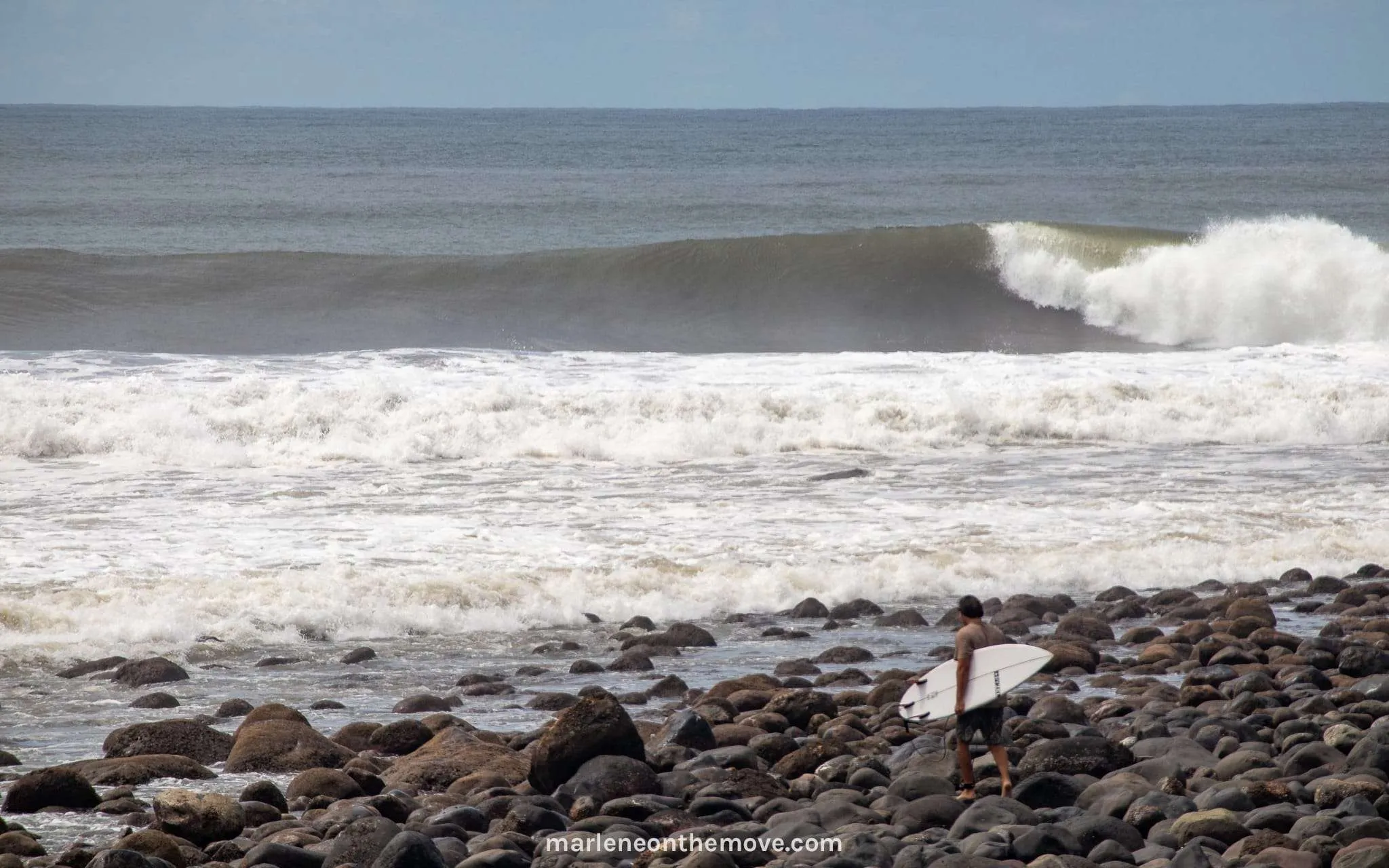 Surfer entering the water in Punta Mango