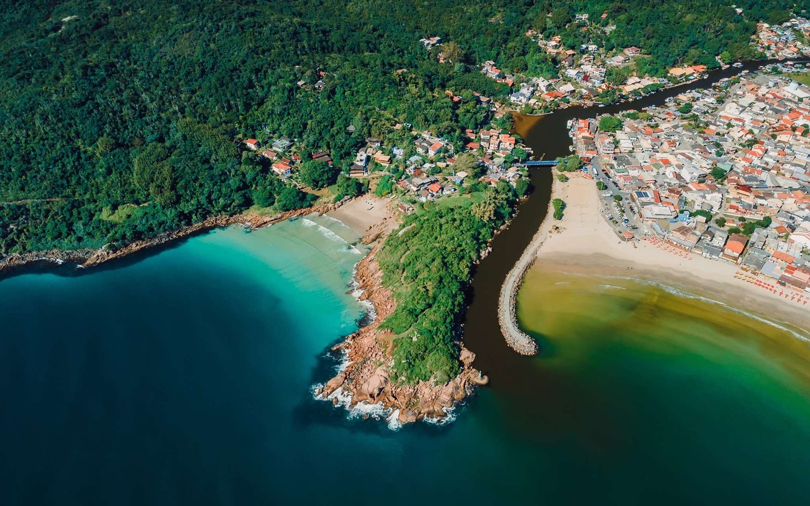 Beaches, rocks, river and ocean in Brazil. Drone view of Barra da lagoa village in Florianopolis.