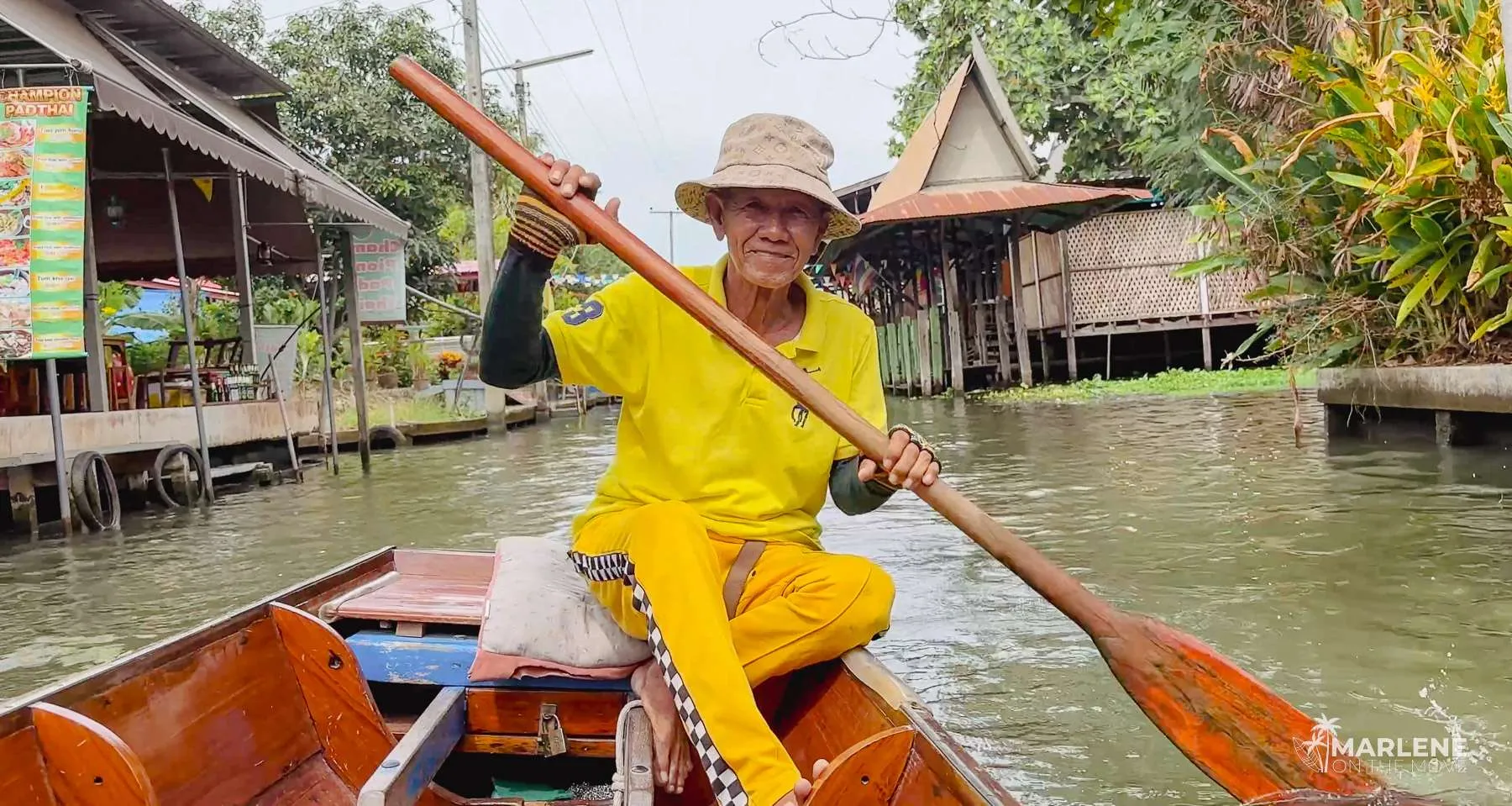 Thai boat driver in a ride through the floating market canals