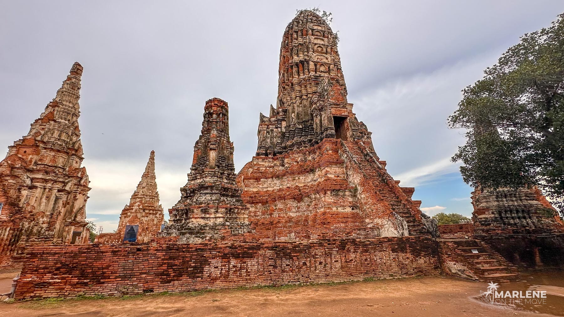 Ruins of Wat Chaiwatthanaram with its characteristic red brick wall and towering prangs, Ayutthaya Historical Park, Thailand