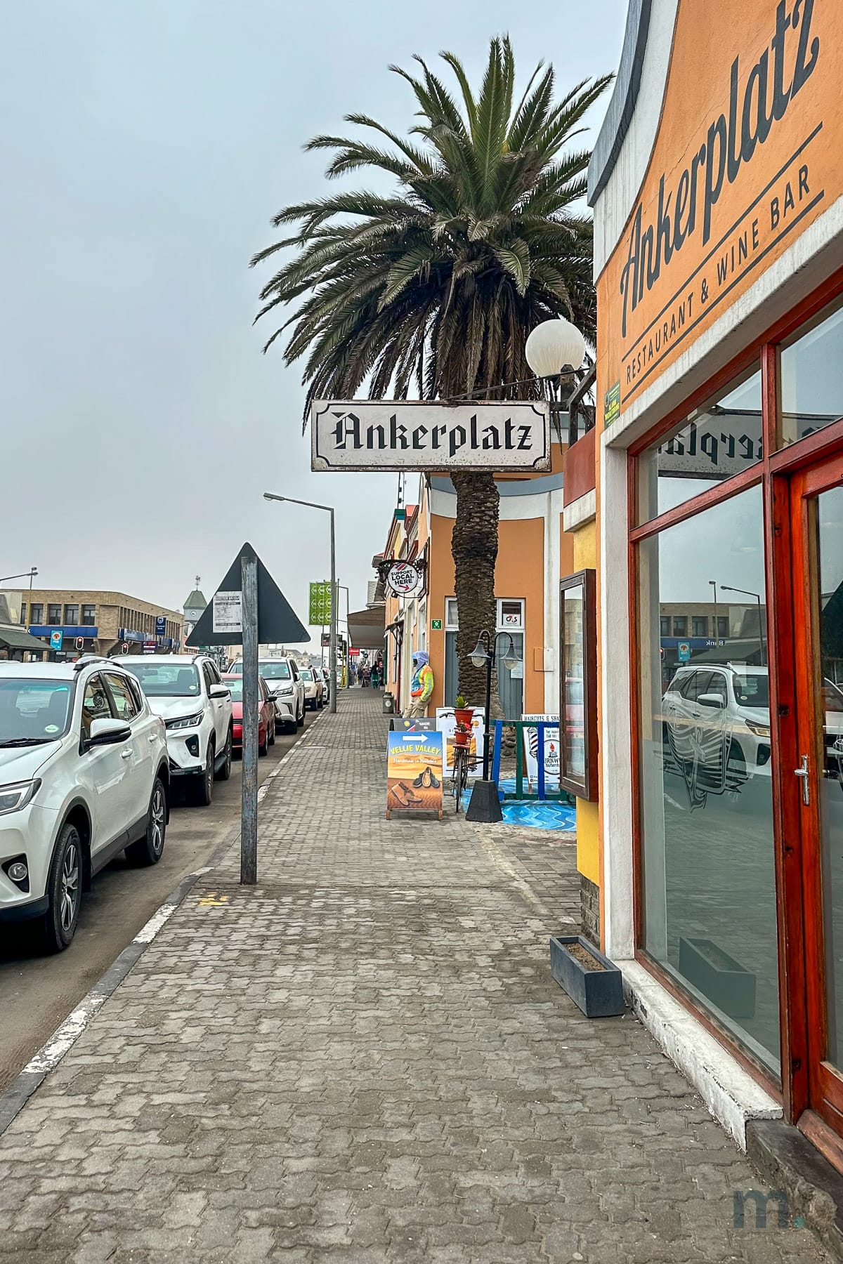 Swakopmund street with German signage and palm trees on Namibia's Atlantic coast