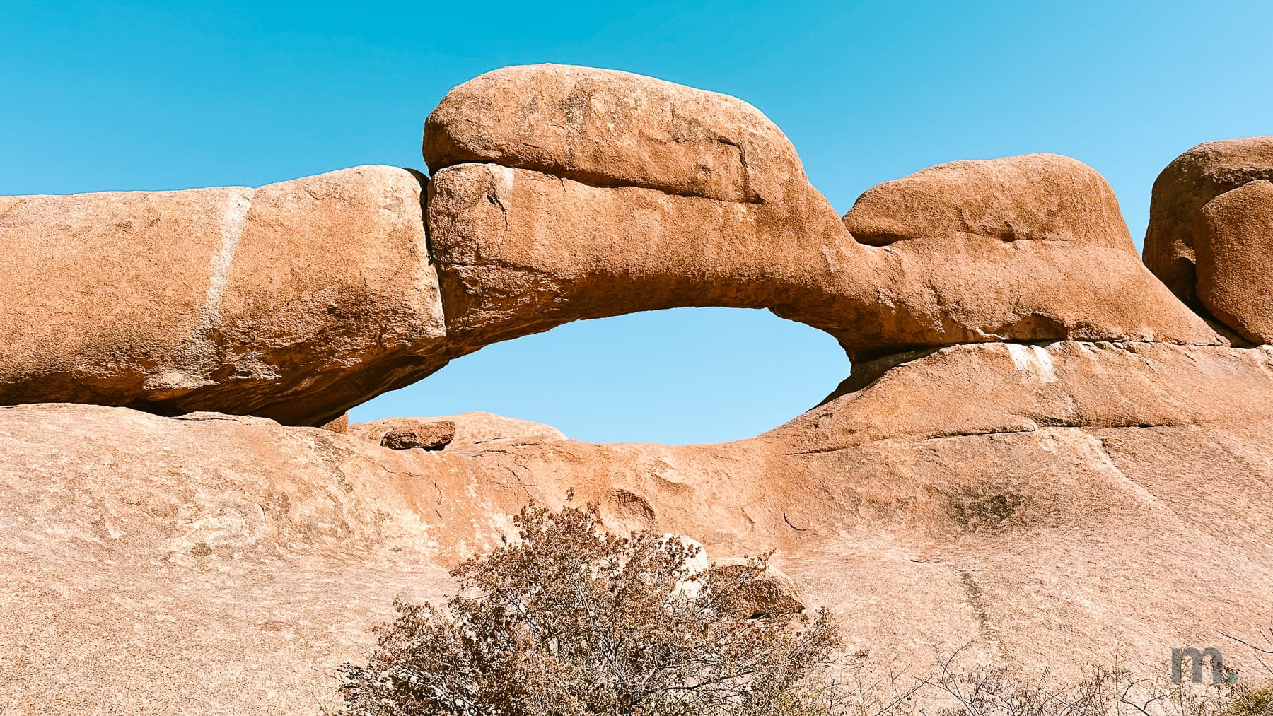 The Spitzkoppe rock arch against a clear blue sky, Namibia